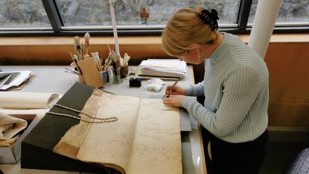 young conservator Icon intern work bench book and paper conservation Credit Anna Gallwey1.jpg