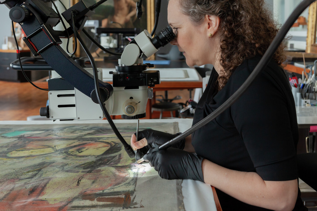 Getty paintings conservator Laura Rivers consolidating paint for Woman-Ochre..jpg