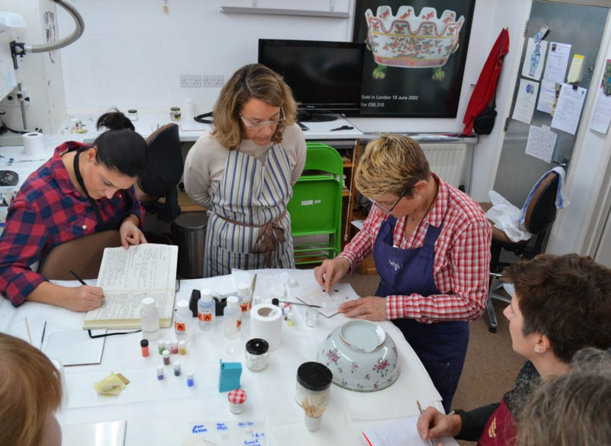 Short course participants gather around to watch a demonstration about making epoxy resin colour fill.