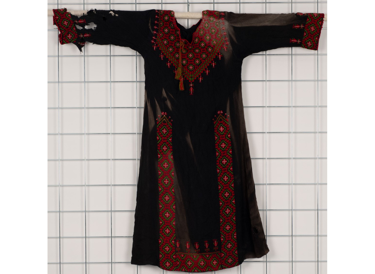The front of the young child’s dress recovered from the Rafah Museum, before conservation