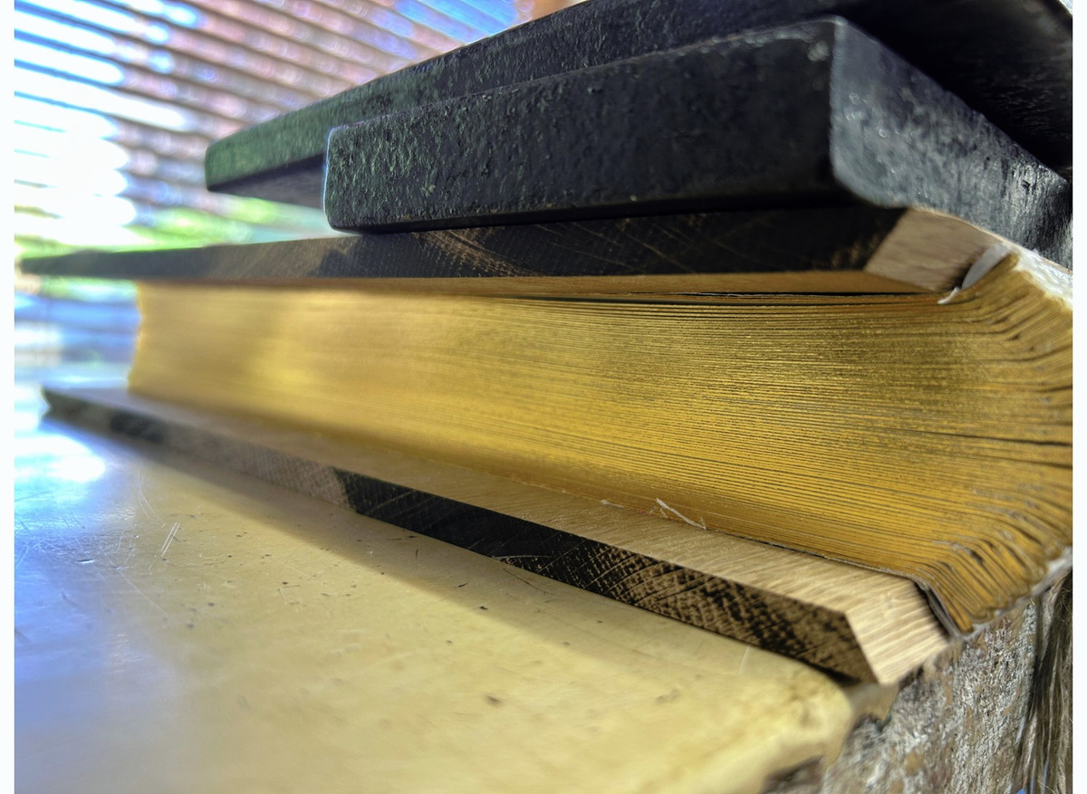 Oak boards profiled at the spine edge to match the angle of the backing