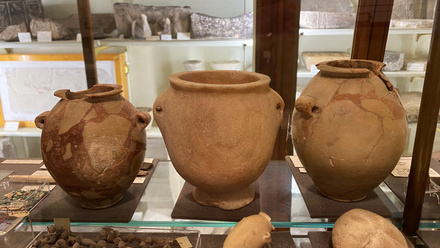 3 brown clay pots in display case ceramics archaeology.jpeg