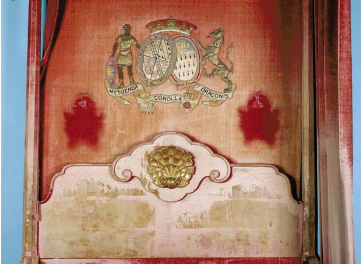 The coat of arms: note the original colour of the silk velvet revealed by the removal of the mirrored sconces