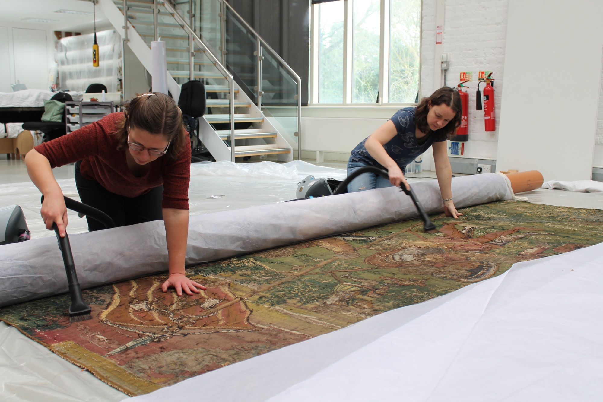 5. Conservators Elaine Owers and Yoko Hanegreefs vacuum clean tapestry  National Trust Textile Conservation Studio.JPG