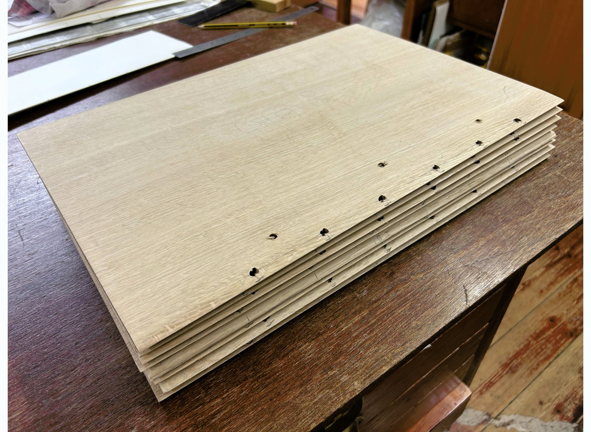 All eight boards, cushioned and drilled in preparation for lacing on