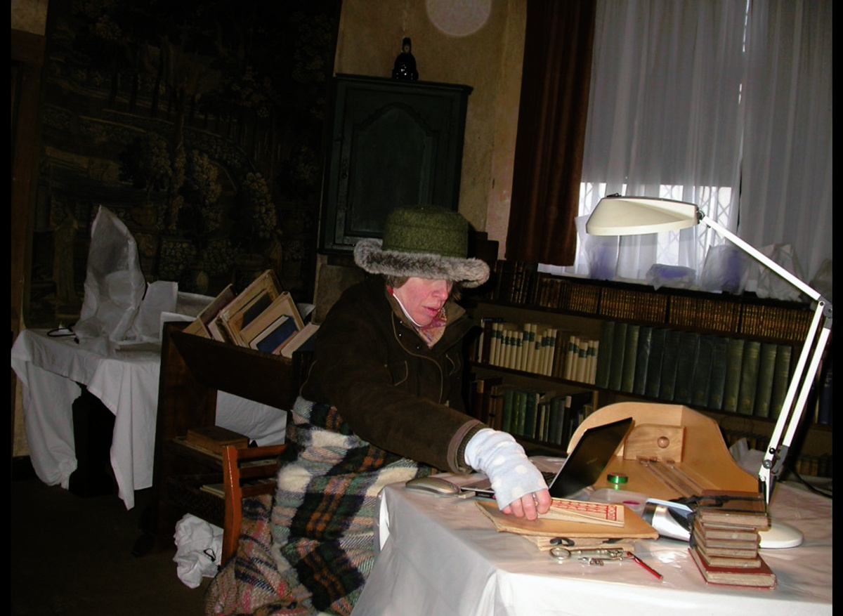Caroline Bendix carrying out a condition survey of books 