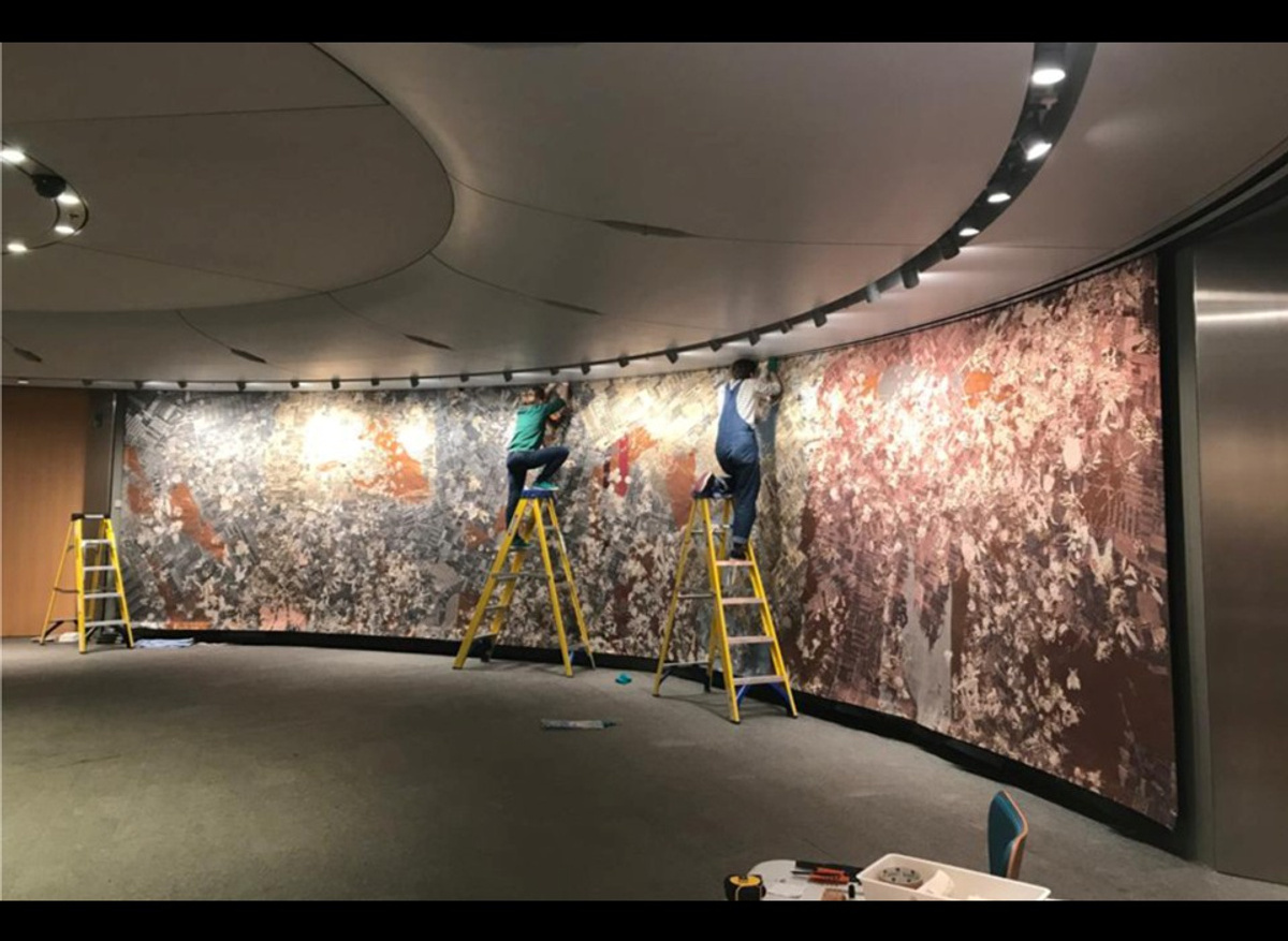 Re-hanging part of Pae White’s, ‘Pomona’ jacquard weave tapestry at Bloomberg London