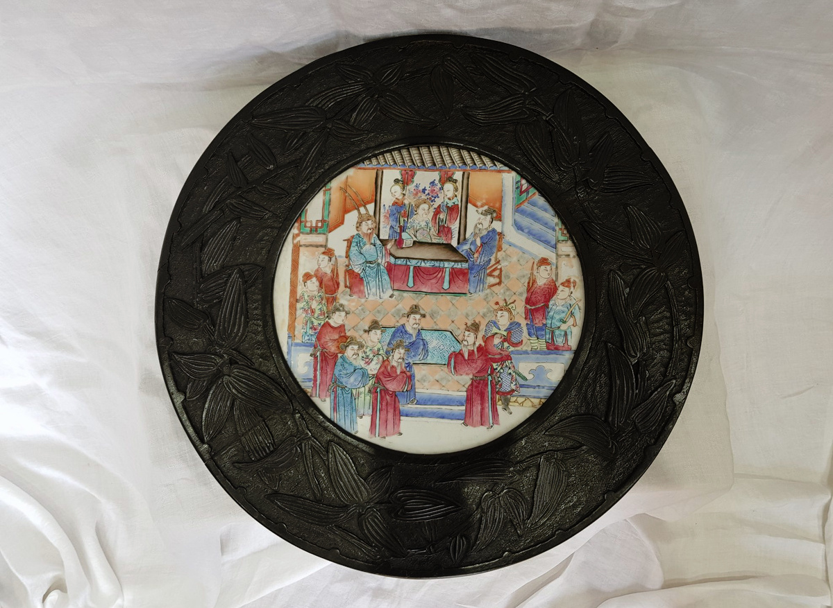 Chinese ebonised and lacquered tripod table with porcelain plaque