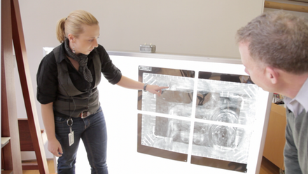 cindy_albertson_and_michael_duffy_examine_x-ray_of_the_portrait.png