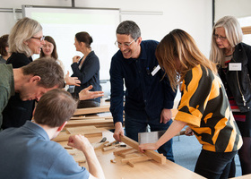 Icon Adapt people at a wood workshop conference.jpeg