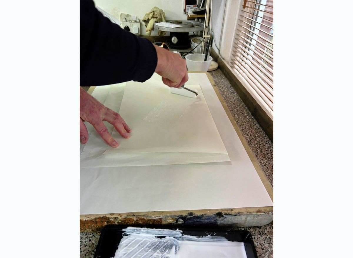  Gluing out the vellum with a roller
