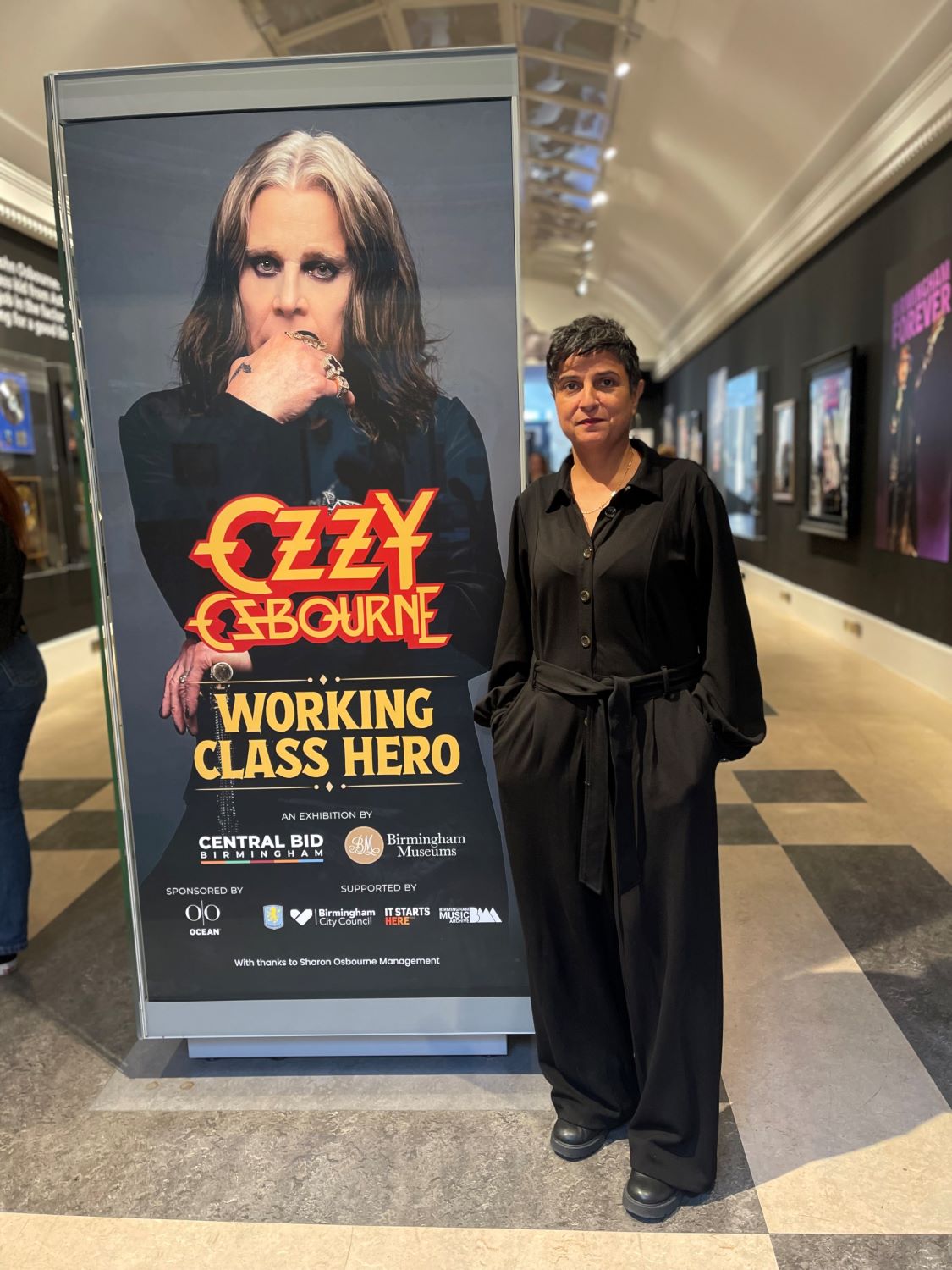 Convo_Sara standing in the  Ozzy Osborne Working Class Hero exhibition which has helped to attract new visitors CREDIT Emma Jhita.jpg