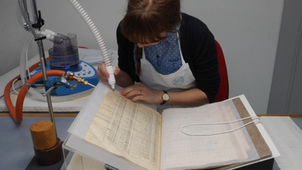 emma_nichols_applying_adhesive_vapour_to_a_leaf_of_the_nominal_roll.jpg