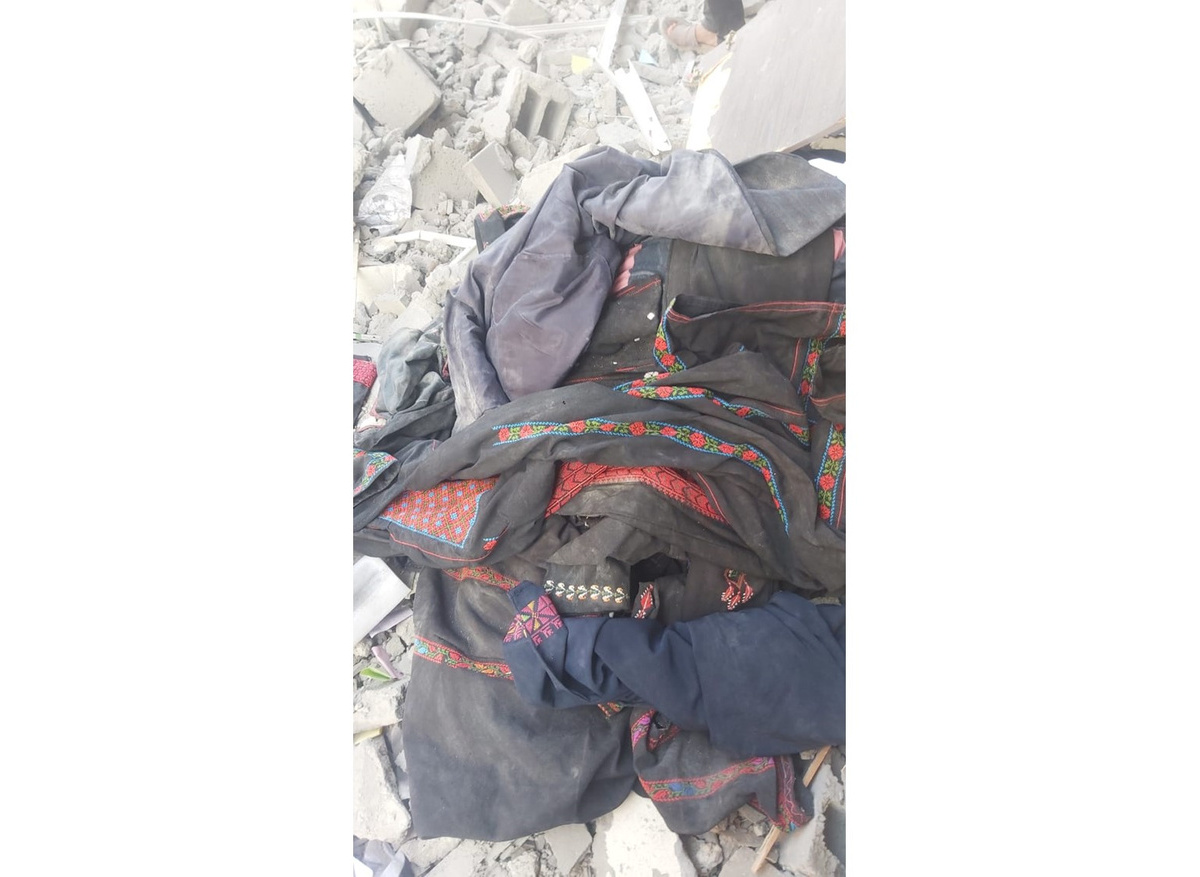 Traditional embroidered thobes, part of the collection of the Rafah Museum, pulled from the rubble