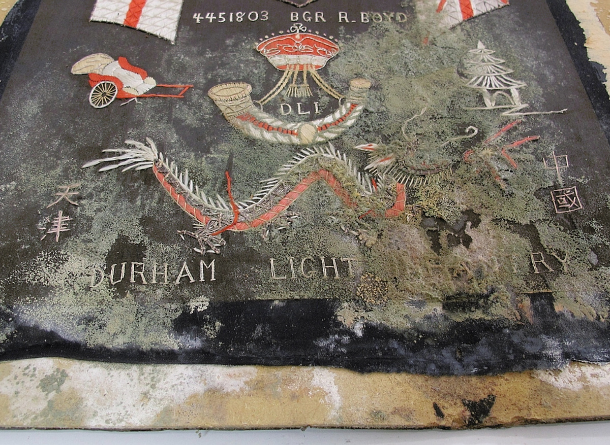 Commemorative embroidered textile - before conservation