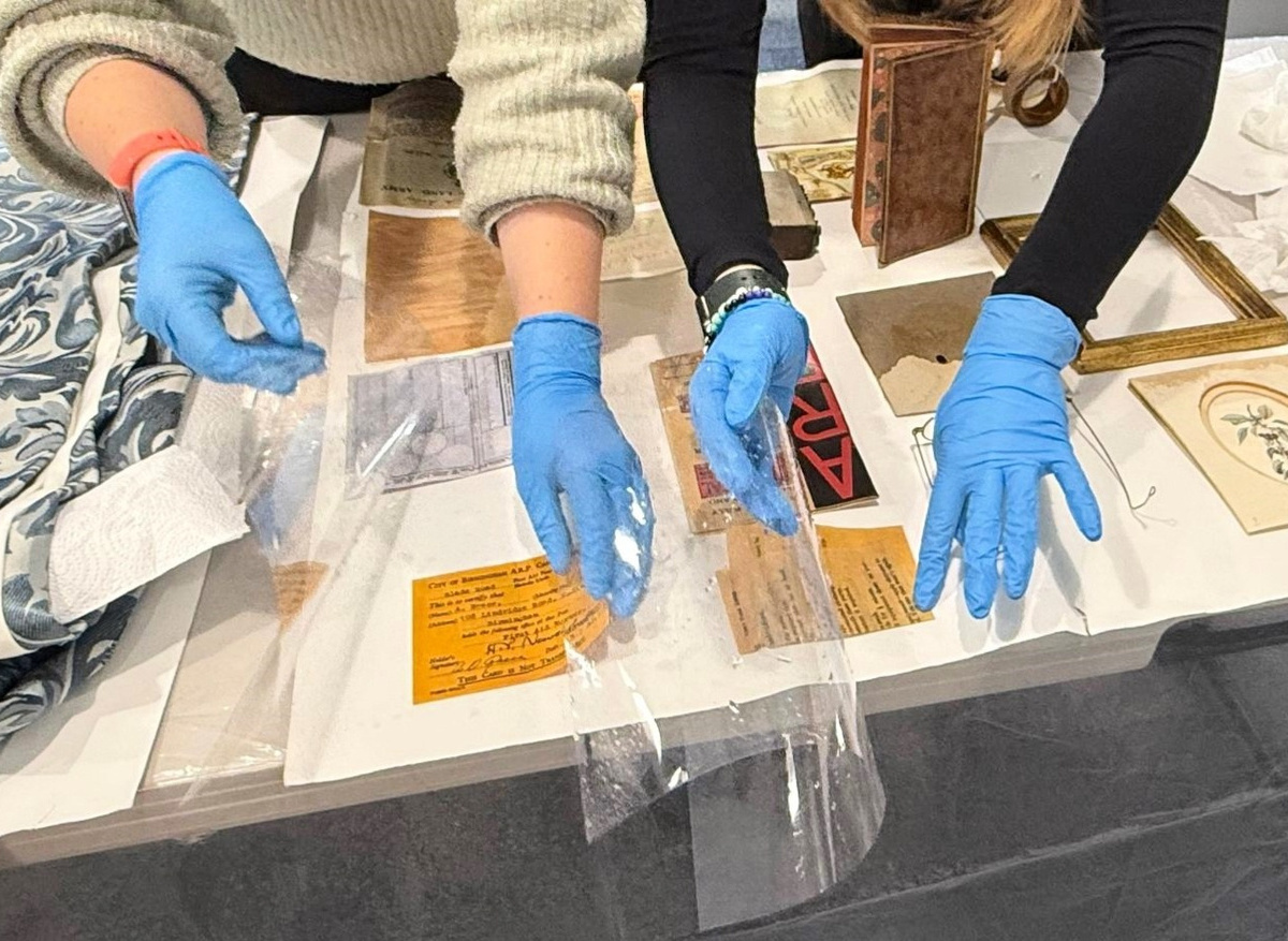 Teaching first aid techniques for wet objects during salvage training.