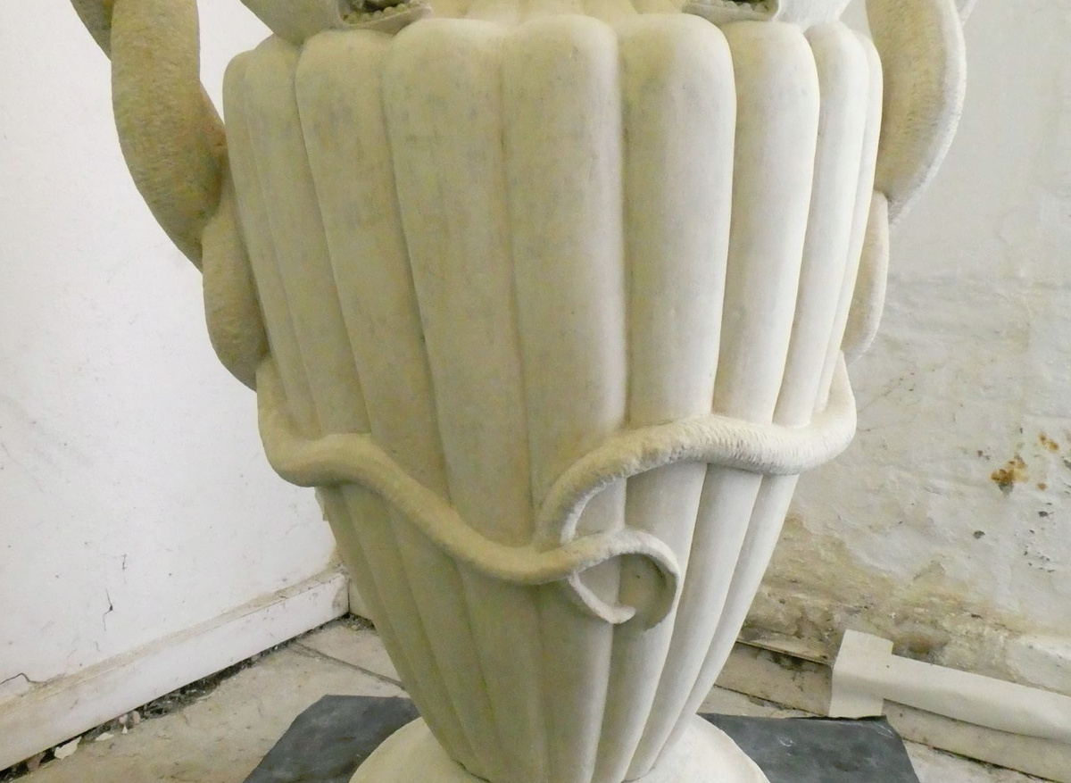 One of two late 18th century limestone urns 
