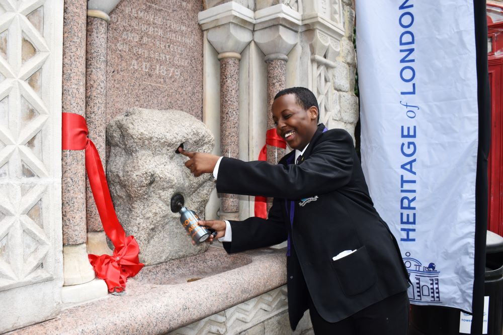 WEB_A young person cuts the ribbon at the launch of Whitechapel Fountain and fills their water bottle CREDIT HOLT.JPG