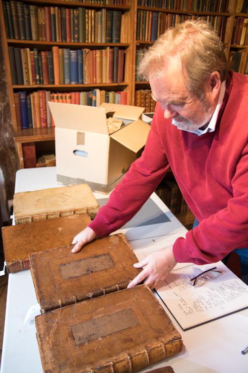 the_curator_at_little_hall_lavenham_returning_the_books_to_the_shelves.jpg