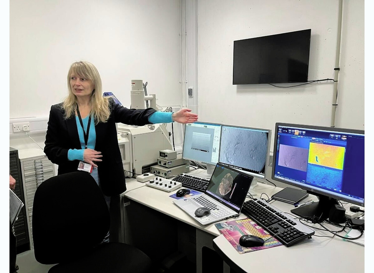 Olga Zagorodnia, PhD researcher, explaining the scanning electron microscopy (SEM) facilities.